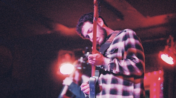 Guitarist in a plaid shirt